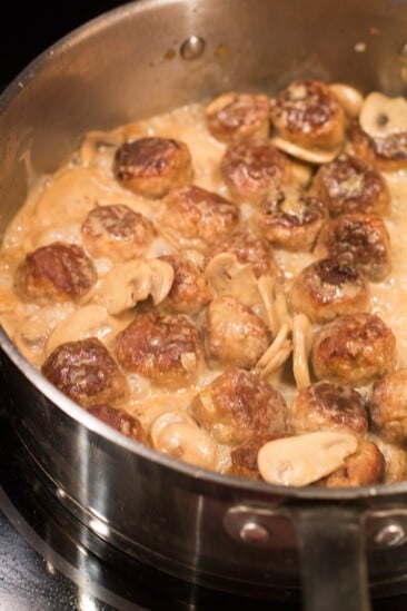 Meatballs in a mushroom sauce cooking on a stove