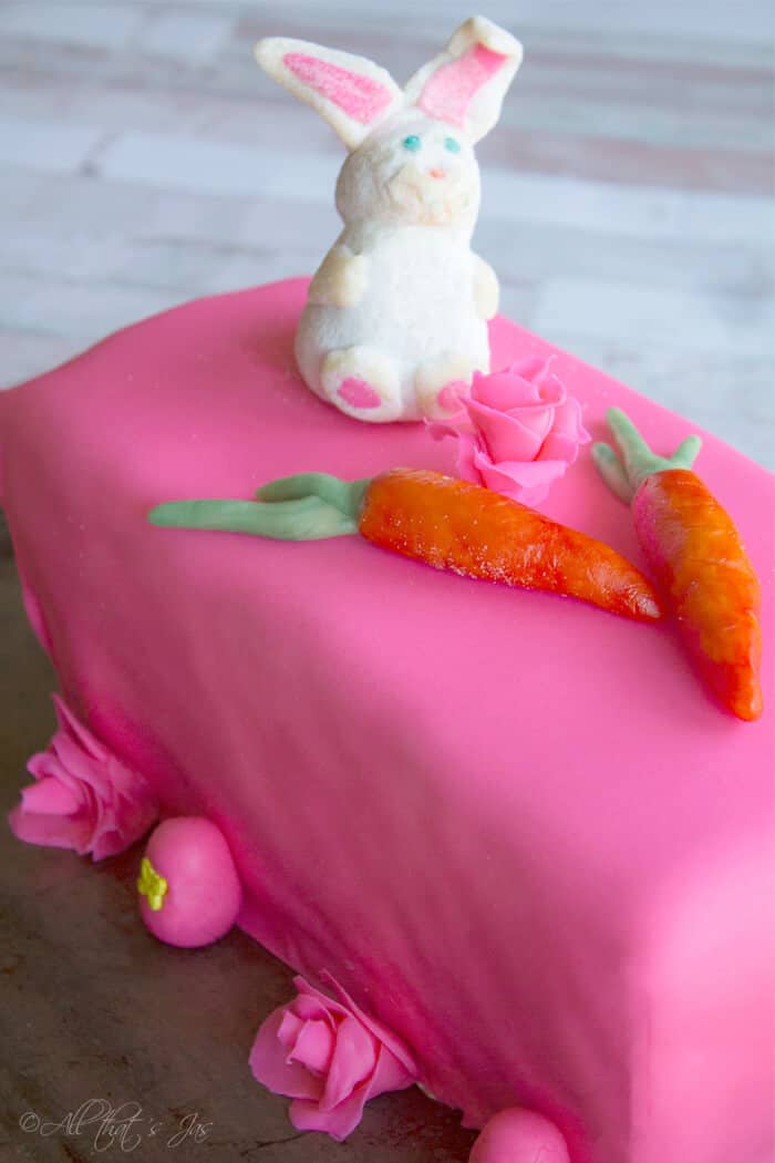 This Easter themed cake topped with carrots and a bunny is festive. 