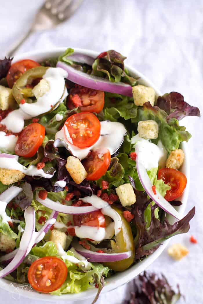 Fresh tomatoes, onions, peppers, bacon bits and croutons come together for a tasty salad. 