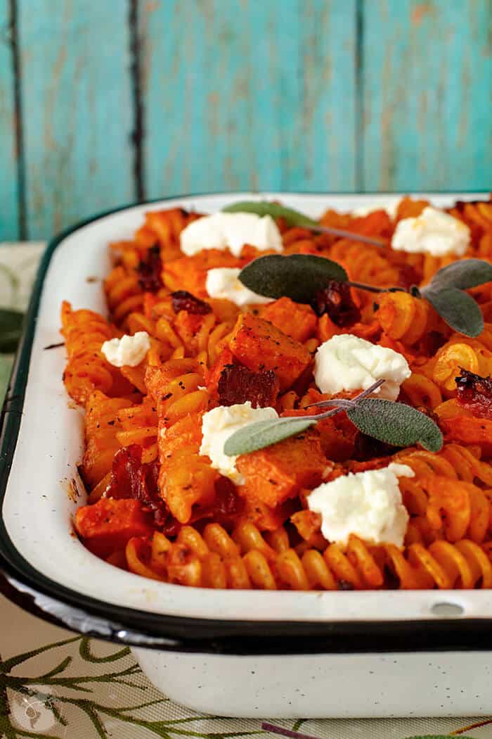 French recipe for delicious vegetarian pasta bake with pumpkin, goat cheese, sage, and sun-dried tomatoes.