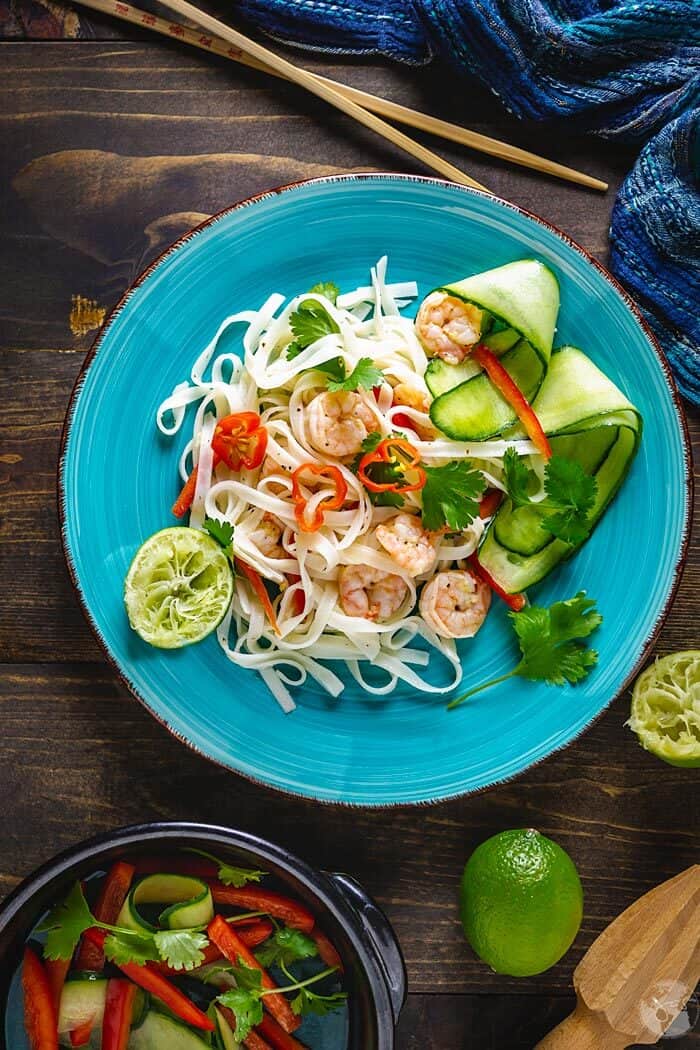 A plate of salad with Thai rice linguine, fresh vegetables and spicy shrimp