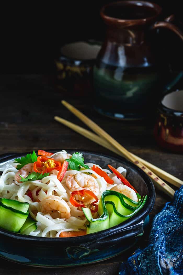 Thai salad with rice noodles in a bowl served with chopsticks.